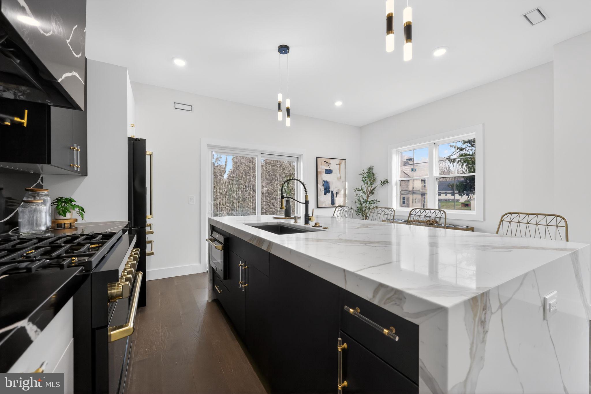 203 Church Street Wayne, PA 19087 - Photo 14 of 30 a kitchen with granite countertop a sink stainless steel appliances a counter space and cabinets