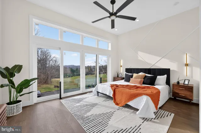 a bedroom with a large bed and a potted plant