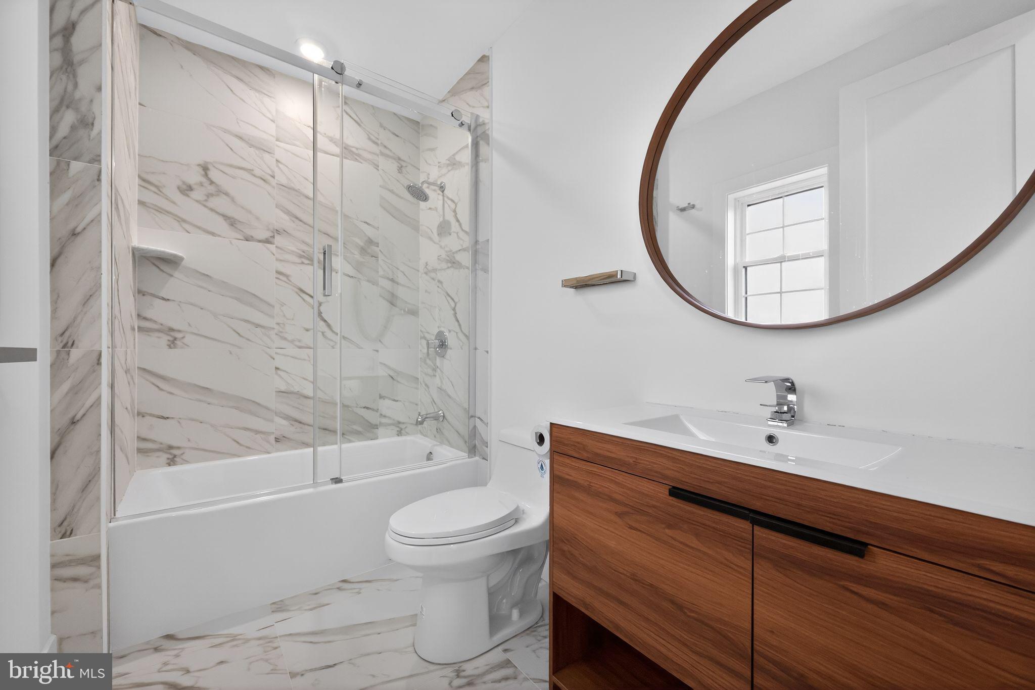 203 Church Street Wayne, PA 19087 - Photo 26 of 30 a bathroom with a sink a toilet and a mirror