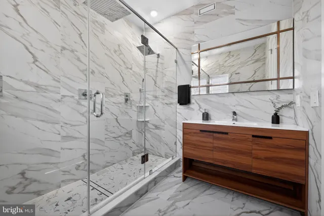 a bathroom with a shower and a sink