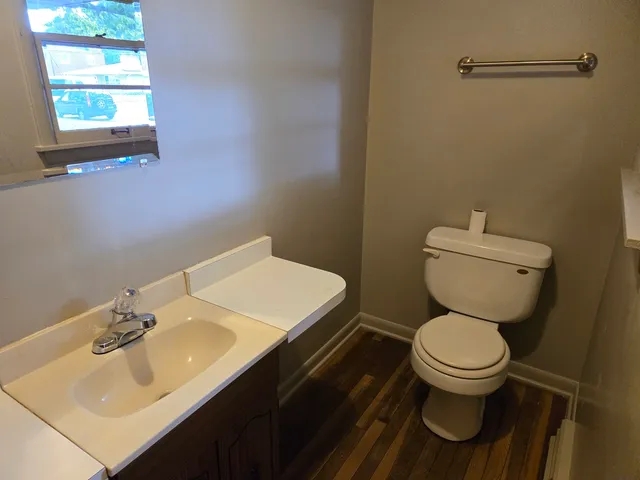 a bathroom with a sink toilet and a mirror
