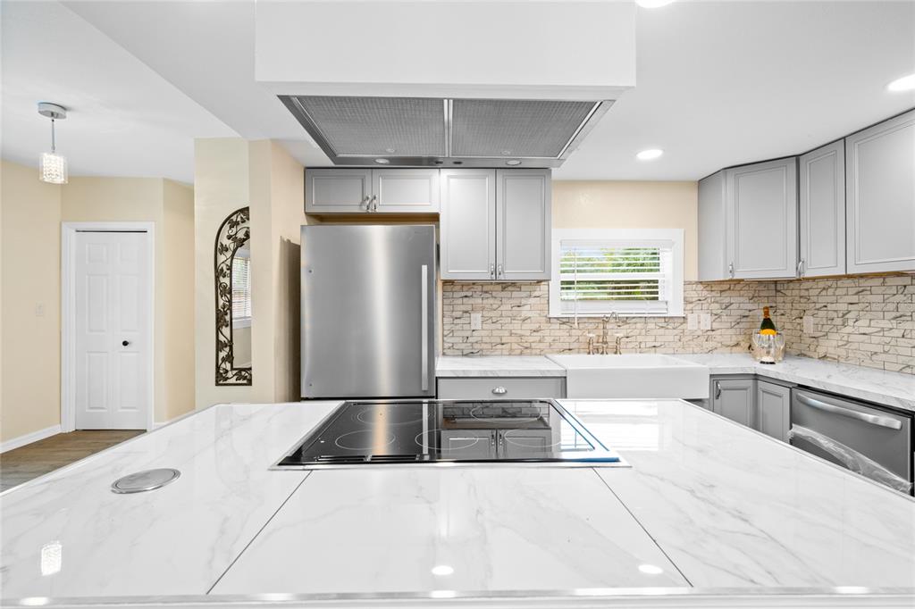 245 South Rhodes Street Mount Dora, FL 32757 - Photo 11 of 38 a kitchen with stainless steel appliances kitchen island granite countertop a refrigerator and a sink