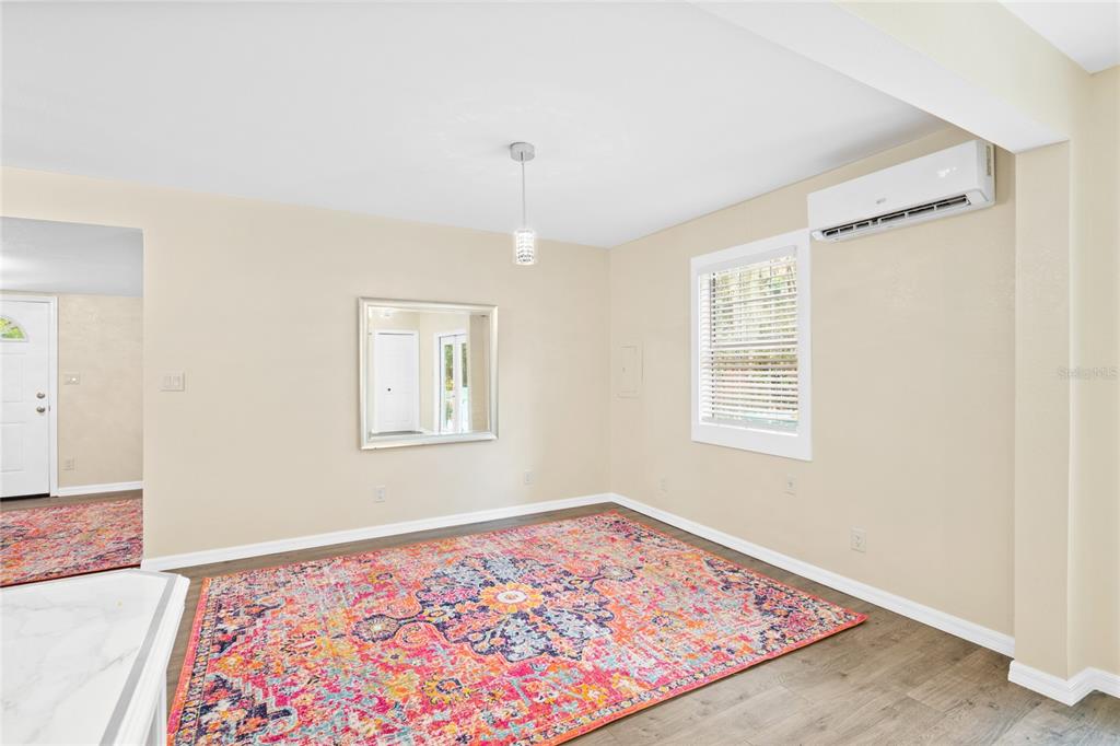 245 South Rhodes Street Mount Dora, FL 32757 - Photo 15 of 38 a view of a room with window and wooden floor