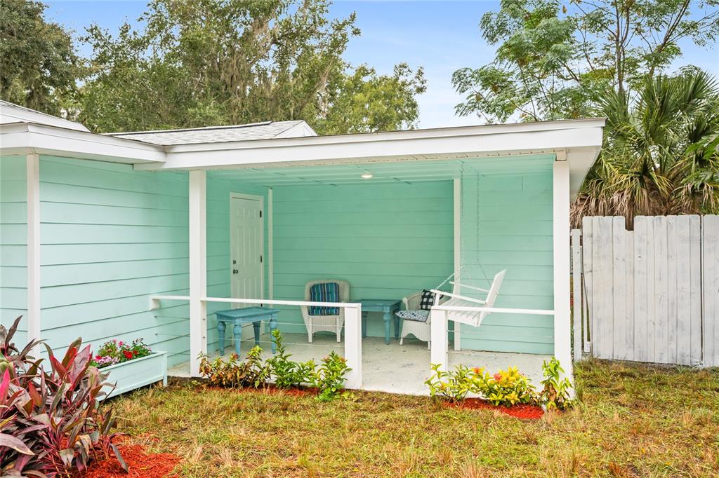 245 South Rhodes Street Mount Dora, FL 32757 - Photo 3 of 38 a balcony with table and chairs and potted plants