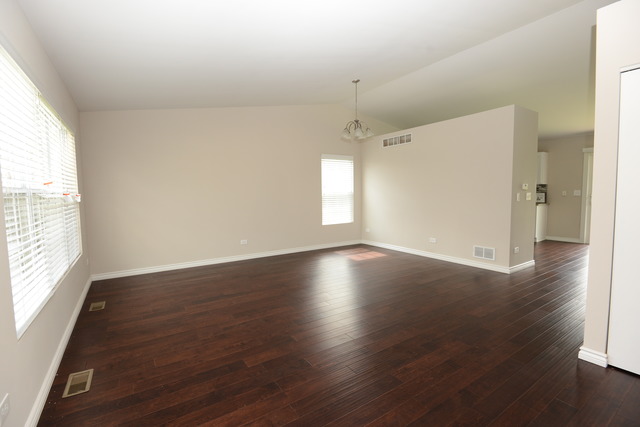 528 Wynbrooke Road Romeoville, IL 60446 - Photo 11 of 25 an empty room with wooden floor and windows