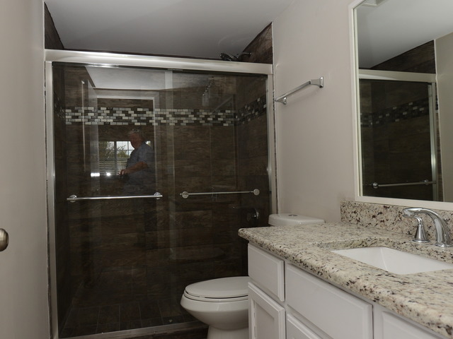 528 Wynbrooke Road Romeoville, IL 60446 - Photo 18 of 25 a bathroom with a granite countertop sink a toilet and shower