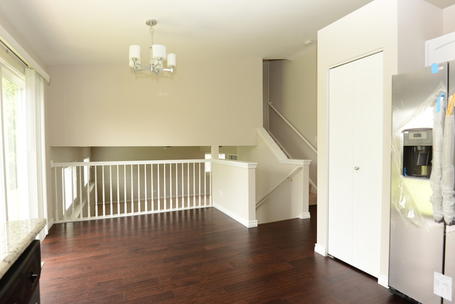 528 Wynbrooke Road Romeoville, IL 60446 - Photo 3 of 25 a view of a livingroom with wooden floor and staircase