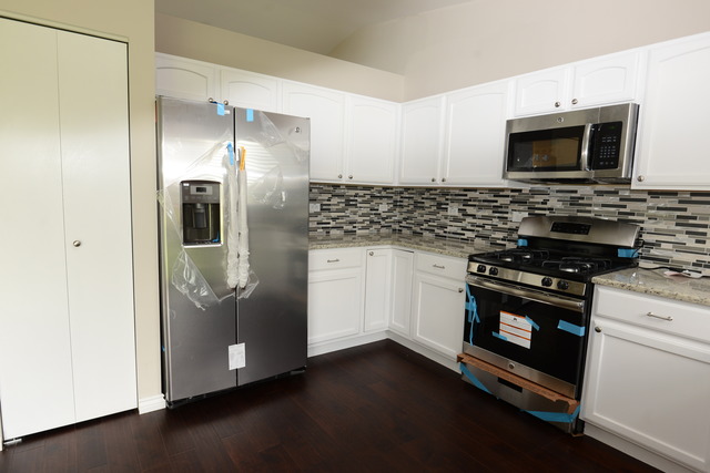 528 Wynbrooke Road Romeoville, IL 60446 - Photo 22 of 25 a kitchen with stainless steel appliances a stove a microwave and a refrigerator
