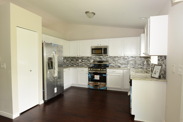 528 Wynbrooke Road Romeoville, IL 60446 - Photo 5 of 25 a kitchen with a refrigerator stove and white cabinets