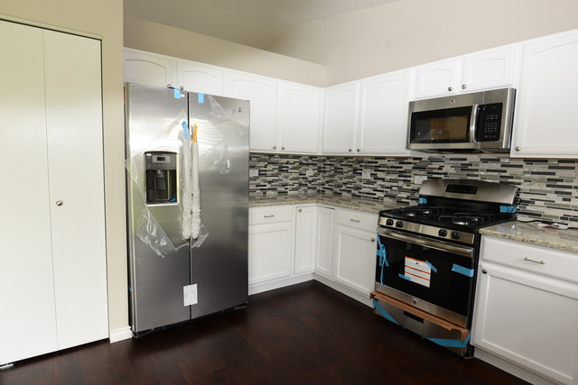 528 Wynbrooke Road Romeoville, IL 60446 - Photo 6 of 25 a kitchen with stainless steel appliances a stove a microwave and a refrigerator