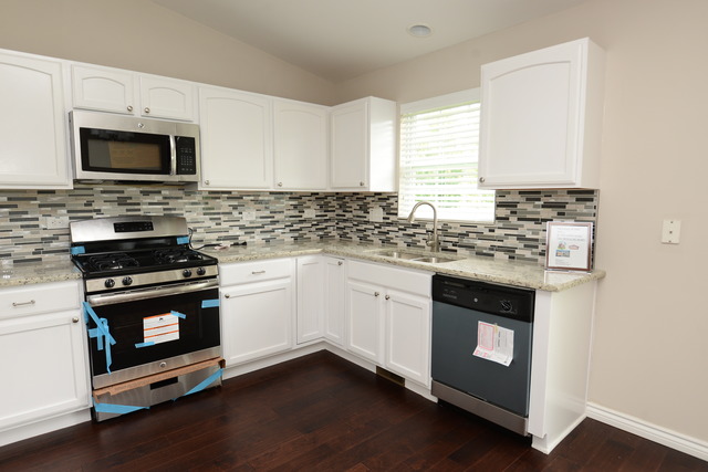 528 Wynbrooke Road Romeoville, IL 60446 - Photo 7 of 25 a kitchen with granite countertop a sink cabinets and stainless steel appliances