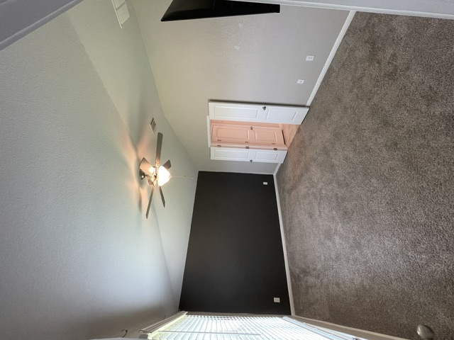 12401 Amber Lynn Path Manor, TX 78653 - Photo 21 of 33 A room with textured walls, a ceiling fan, and a view of a closet.