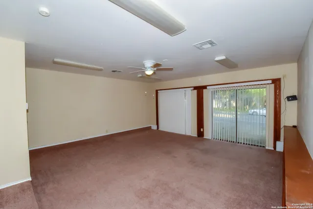 a view of an empty room with a window