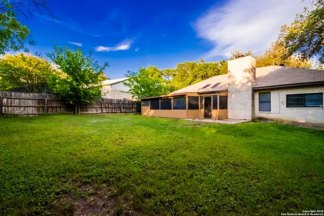 a view of a house with a backyard porch and sitting area
