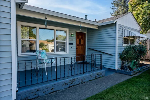 a view of a house with a yard and wooden floor