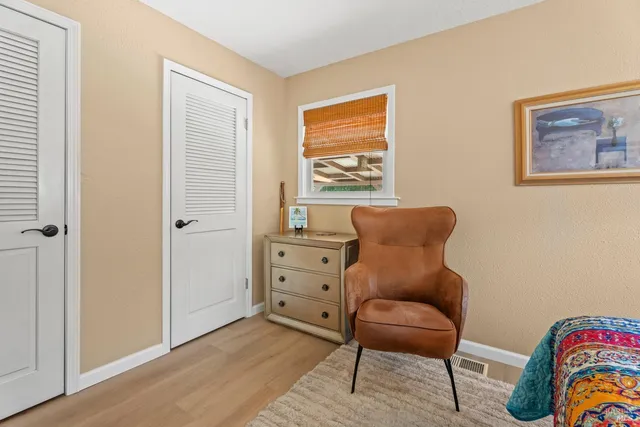 a bedroom with a bed and chair
