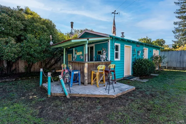 a view of a house with a backyard porch and sitting area