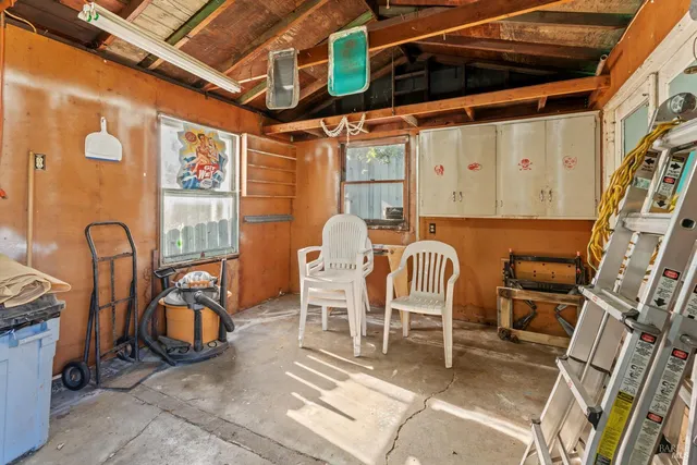 a view of a brick house with wooden fence next to a yard