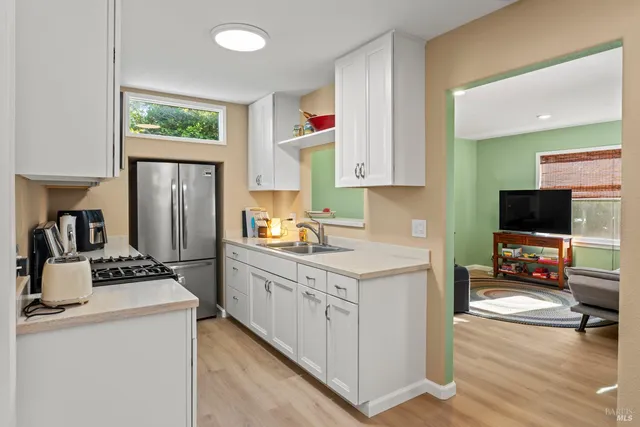 a kitchen with a stove microwave and sink