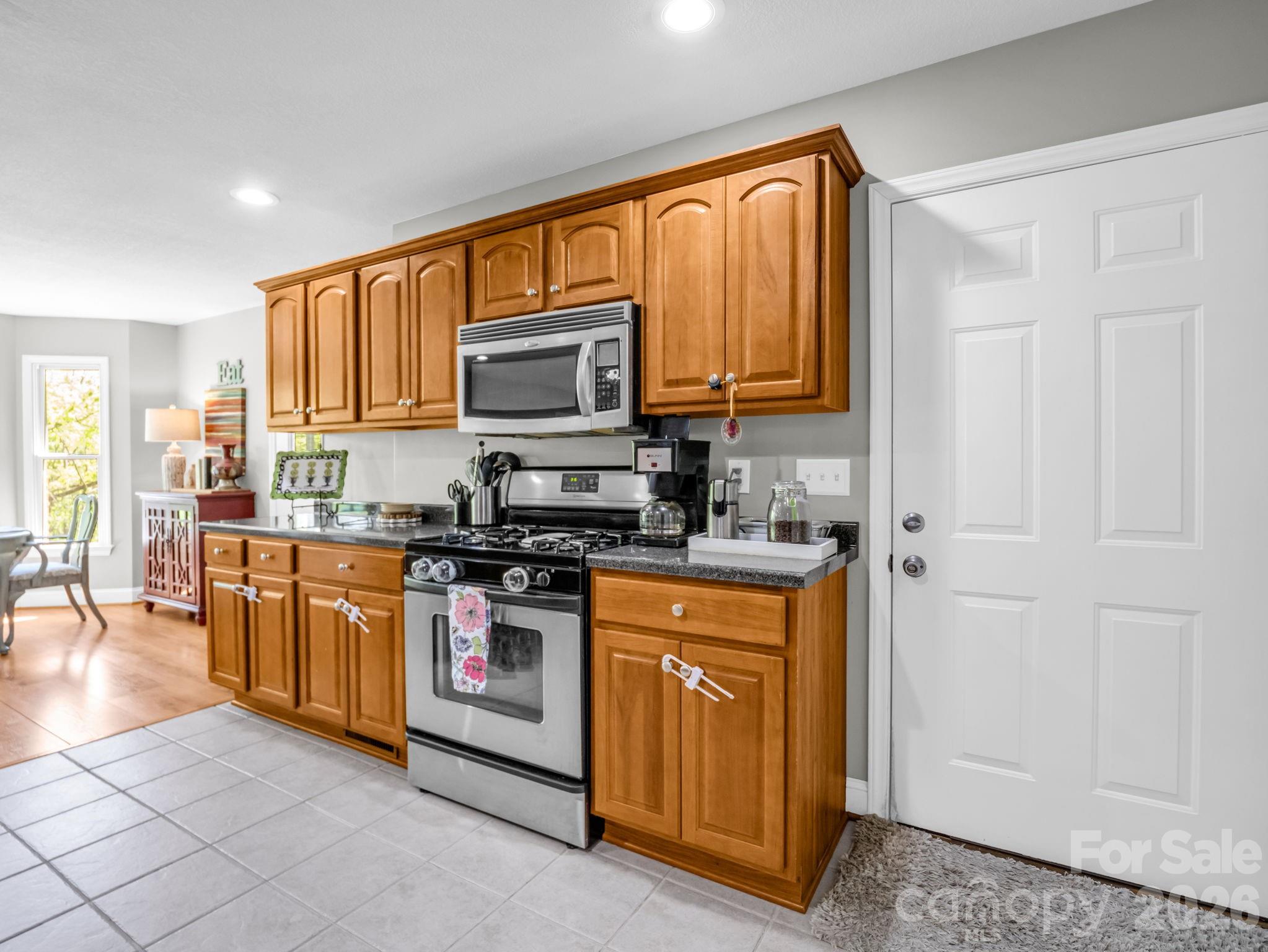 158 Shady Woods Lane Rutherfordton, NC 28139 - Photo 11 of 41 a kitchen with stainless steel appliances granite countertop a stove a sink and a microwave