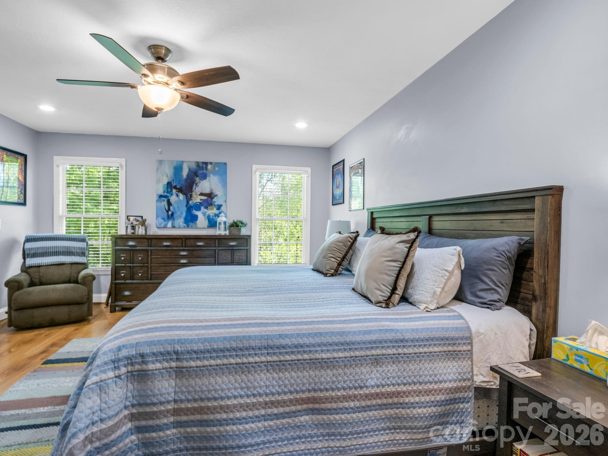 158 Shady Woods Lane Rutherfordton, NC 28139 - Photo 18 of 41 a bedroom with a large bed and a chandelier
