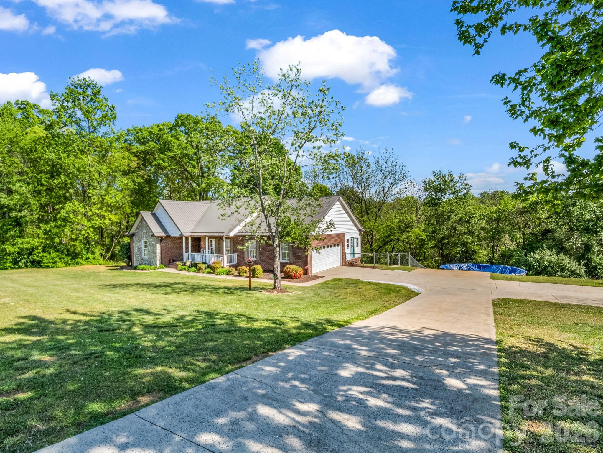 158 Shady Woods Lane Rutherfordton, NC 28139 - Photo 2 of 41 a front view of a house with a yard and trees