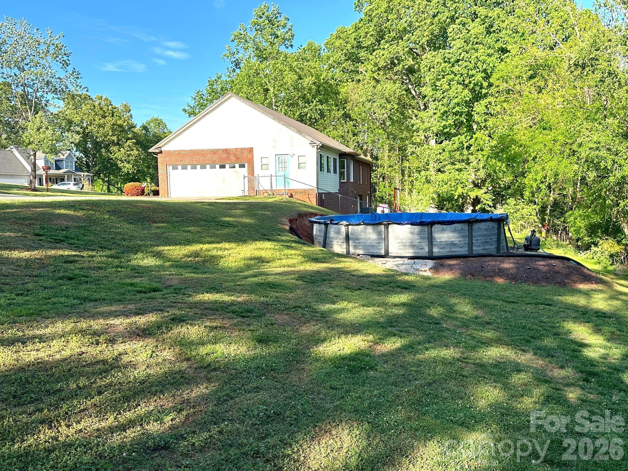 158 Shady Woods Lane Rutherfordton, NC 28139 - Photo 32 of 41 a front view of a house with garden