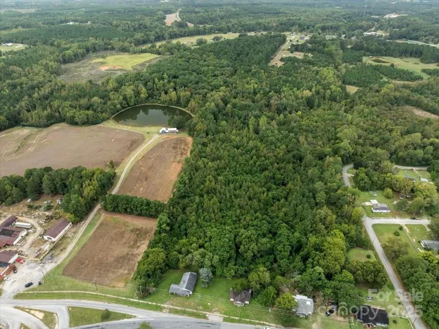 an aerial view of a house with a yard and lake view