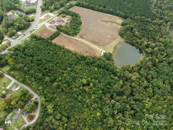 an aerial view of a house with a yard and plants