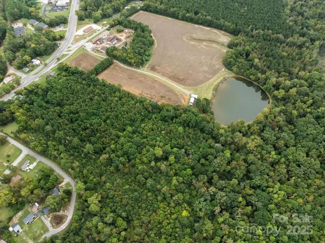 an aerial view of a house with a yard and plants
