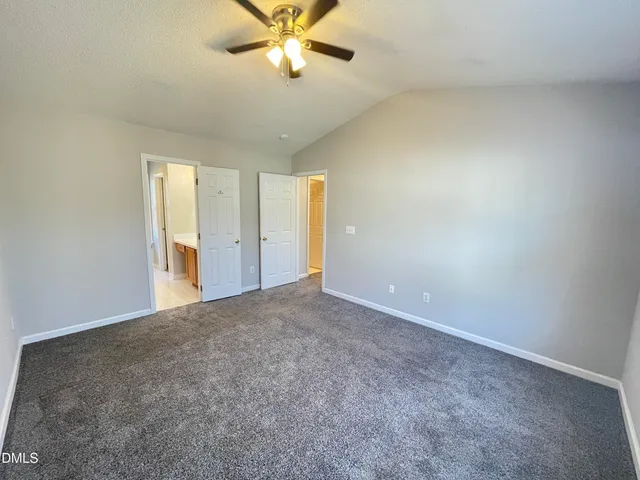 a bathroom with a double vanity sink a toilet and a mirror