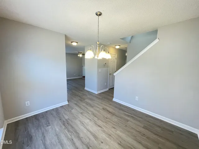 a kitchen with stainless steel appliances granite countertop a refrigerator a stove top oven a sink dishwasher and wooden floor