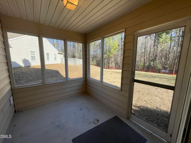 a view of a house with backyard and porch