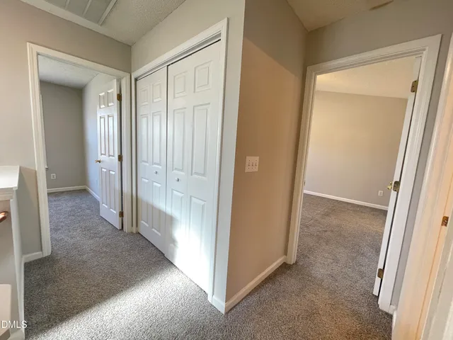 a view of a hallway with wooden shelves