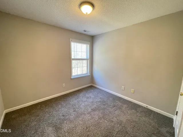 an empty room with closet area