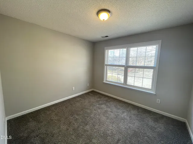 an empty room with a empty space and a window