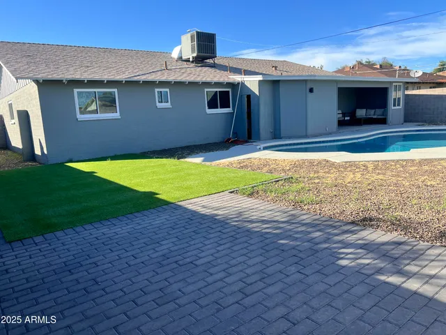 a kitchen with granite countertop a sink stove and microwave