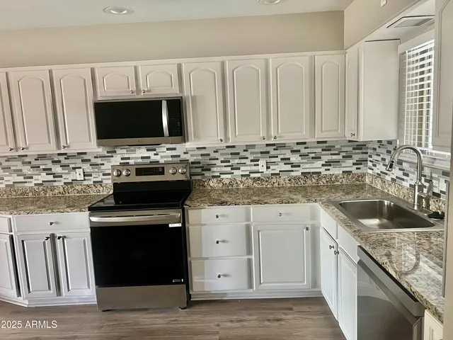 a kitchen with a refrigerator stove and sink