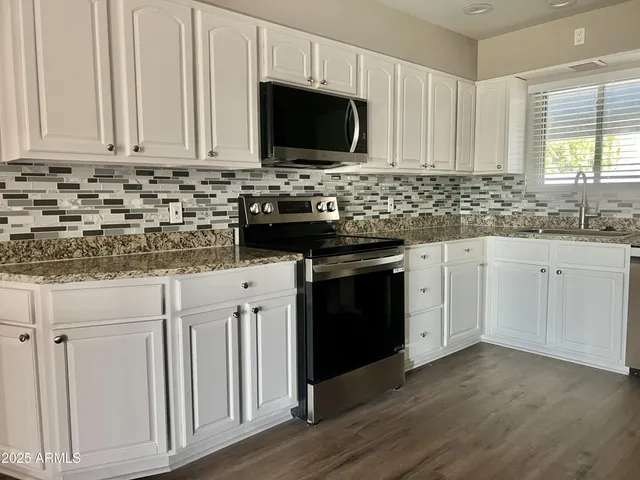 a view of a swimming pool with a yard