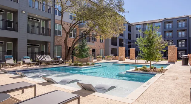 a view of a house with swimming pool and sitting area