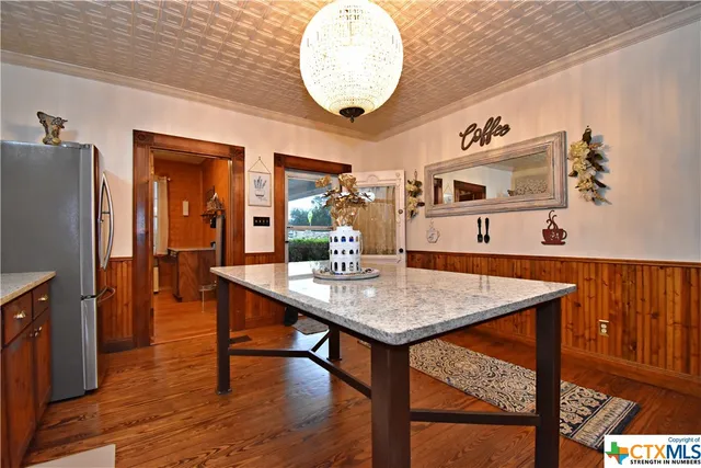 a kitchen with a dining table and chairs
