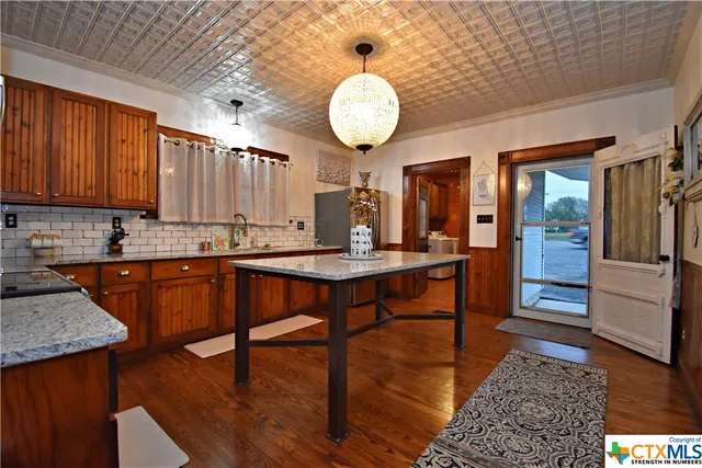 a living room with furniture a rug and a window