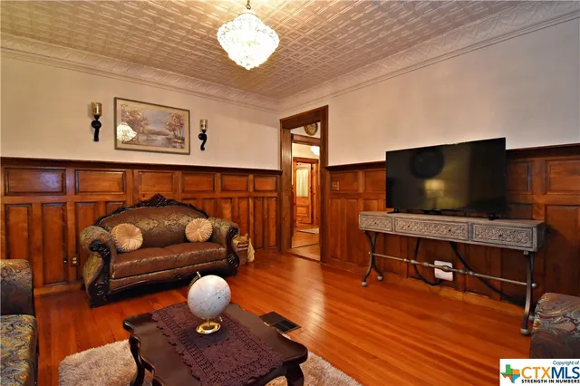 a living room with furniture a window and a clock