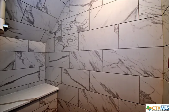 a white toilet sitting next to a bathroom sink and vanity