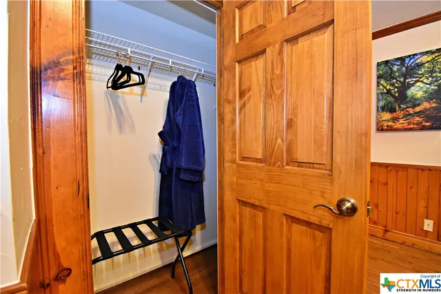 a bedroom with furniture and wooden floor
