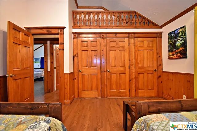 a bedroom with bed and a chandelier