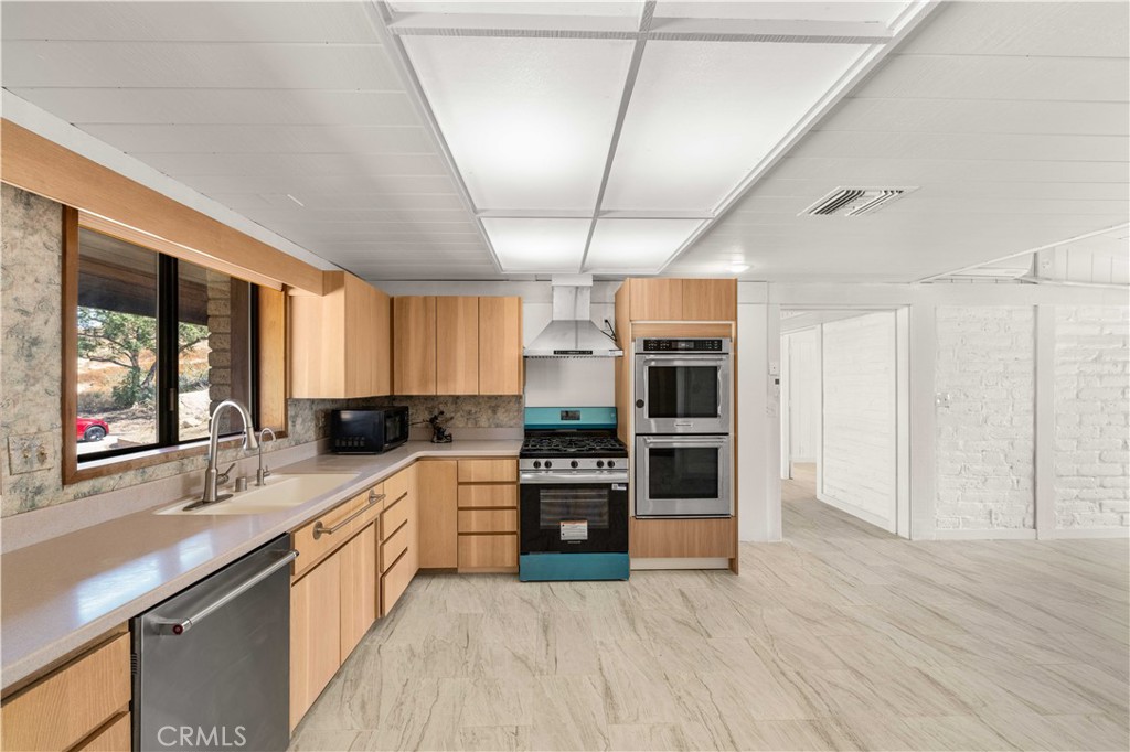6308 Hawarden Drive Riverside, CA 92506 - Photo 12 of 37 a large kitchen with stainless steel appliances granite countertop a stove and cabinets