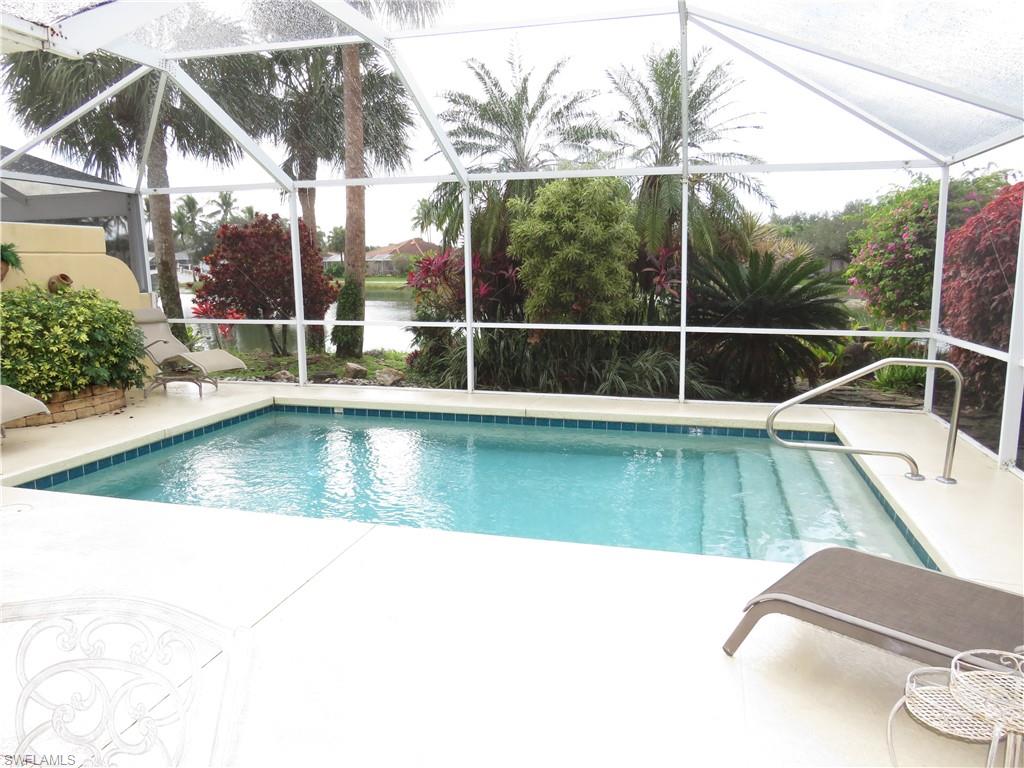 3732 Exuma Way Naples, FL 34119 - Photo 16 of 24 a view of a swimming pool with a yard
