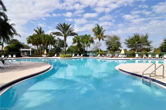 a view of a swimming pool with a table and chairs