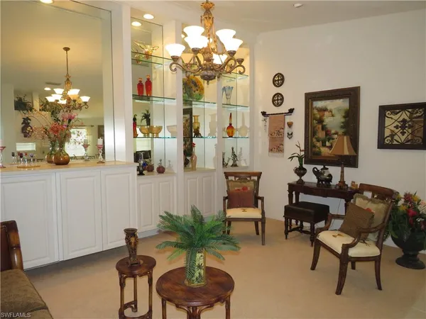 a view of a dining room with furniture and chandelier